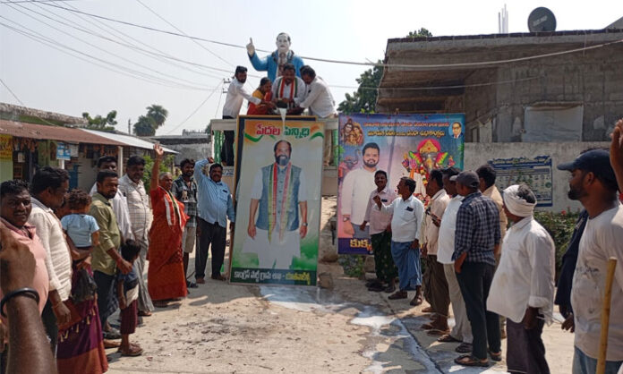 Congress leaders and villagers perform Milk Abhishekam for Minister Uttam Kumar Reddy’s portrait after ₹9.40 crore is sanctioned for BT roads from Yatavakilla to nearby villages.