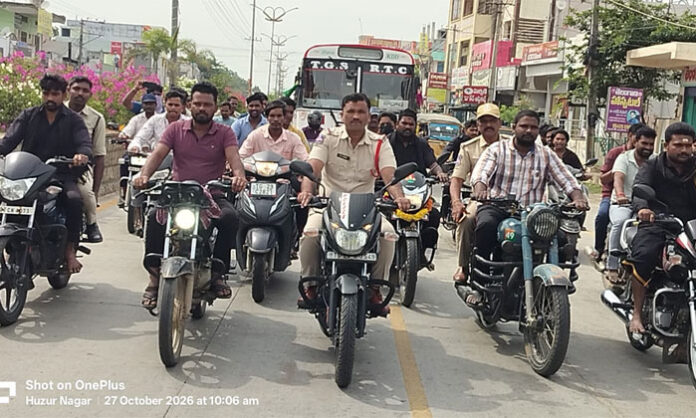 Police personnel participate in a bike rally in Huzurnagar to pay tribute to police martyrs during Police Commemoration Week.