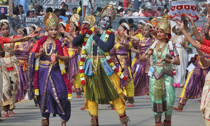 Lord Malayappa Swamy is taken in procession on the Chinna Sesha Vahanam during Tirumala Navaratri Brahmotsavams, accompanied by traditional folk art performances.